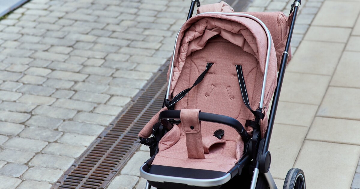 An empty stroller outside a shop, as China's online baby gear sales rose 12.7% in H1 2026