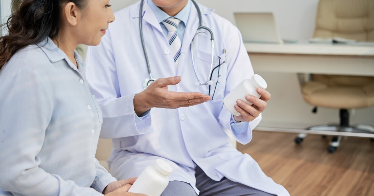 A doctor showing results on a tablet to a patient in a clinic