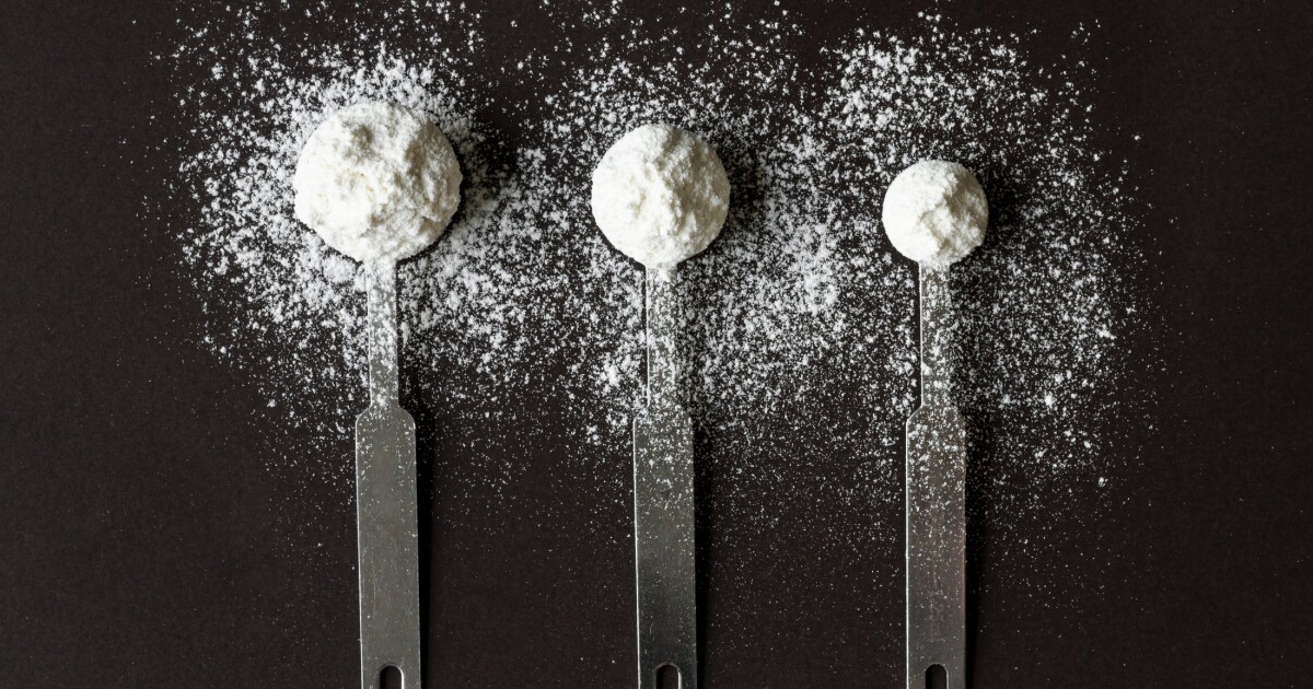 Spoons of protein powder seen from above